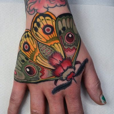 Hand tattoo by Jacob WIman #JacobWiman #tattooartist #tattoodo #tattoodoapp #awesometattoo #besttattoo #neotraditional #moth #butterfly #color #hand #handtattoo