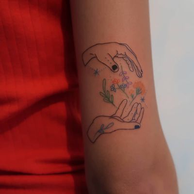 Illustrative tattoo by Katie Mcpayne #KatieMcpayne #illustrative #linework #queertattooer #vegantattoo #colortattoo #fineline #hands #flower #floral #arm #stars