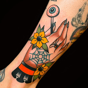 Hand tattoo by Wyatt Dalzell #WyattDalzell #Halloweentattoos #halloweentattoo #halloween #Samhain #AllHallowsEve #handtattoo #spiderweb #eyeball #flowers #spider #traditional #color 