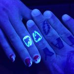 UV ink couple tattos by Unknown Artist #coupletattoos #matchingcoupletattoo #relationshiptattoo #matchingtattoosforcouples #uvink #toothtattoo #tooth #fingertattoos