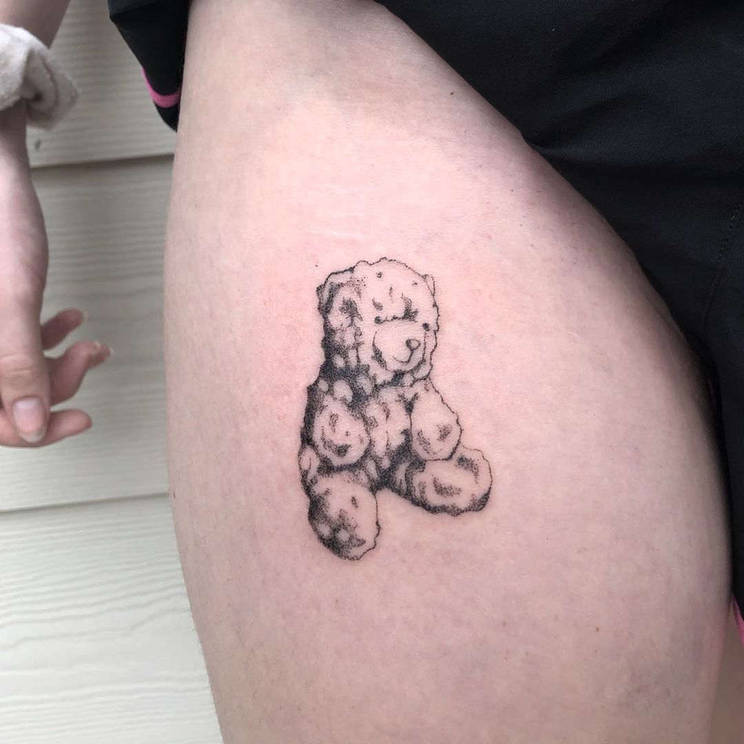 Minimalistic cute teddy bear tattoo located on the