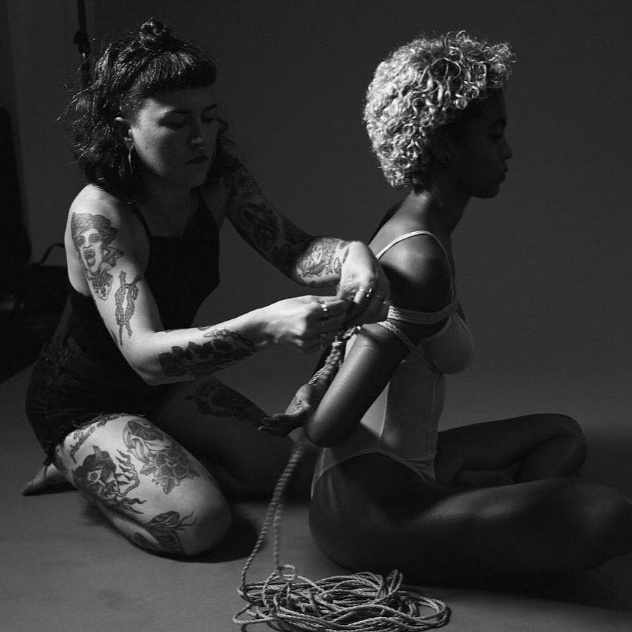Sara Elise being tied by Daemonum X and photo by Lanee Bird #DaemonumX #tattoocollector #leatherdyke #ropetop #shibari 