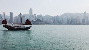 Victoria Harbour, featuring a classic Hong Kong junk boat