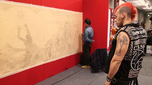 A convention attendee watching live drawing exhibition #12thFlorenceTattooConvention #FlorenceTattooConvention #Florence