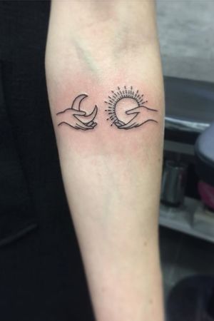 Feminine hands holding the sun and moon forearm tattoo by Carly Mason of Inkspiration Tattoo #CarlyMason #small #sun&moonTattoo #blackwork  #sun #moon #TattooWithMeaning