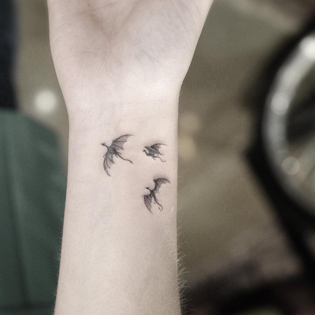 small blue dragon flying, forearm tattoo, dragon tattoos for women, blurred  background | Dragon tattoo for women, Small dragon tattoos, Dragon tattoo  designs