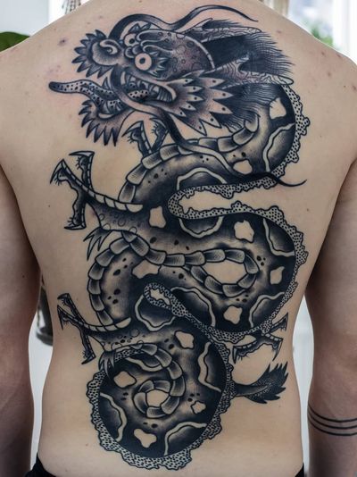 Dagon tattoo by Tattoo Sved #Tattoosved #traditional #blackandgrey #backtattoo #backpiece #dragontattoos #dragontattoo #dragon #mythicalcreature #myth #legend #magic #fable