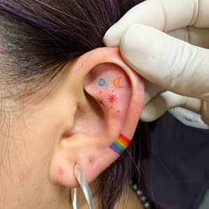 Ear tattoo by Tan Tattoo #TanTattoo #eartattoo #rainbow #stars #moon #color