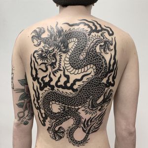 fire dragon tattoo by Kwong Tattoo #kwongtattoo #kwong #backtattoo #fire #blackwork #dragontattoos #dragontattoo #dragon #mythicalcreature #myth #legend #magic #fable