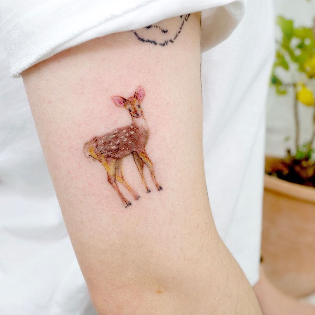 Black ink tiny wrist tattoo of deer with flowers  Rose tattoos on wrist Tiny  wrist tattoos Cute tattoos on wrist
