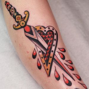 Traditional style heart and dagger tattoo by Hugo Carrasco of Siha Tattoo #HugoCarrasco #heartanddagger #heartanddaggertattoo #heart #dagger #knife
