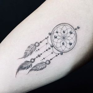 Illustrative tattoo by Fan Wu #FanWu #illustrative #linework #drawing #dreamcatcher #feathers #arm