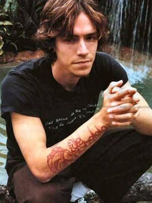Brandon Boyd’s red ink Buddhist mantra tattoo #BrandonBoyd #incubus #iconictattoos #rockmusic #90stattoos #colourtattoos #buddhist