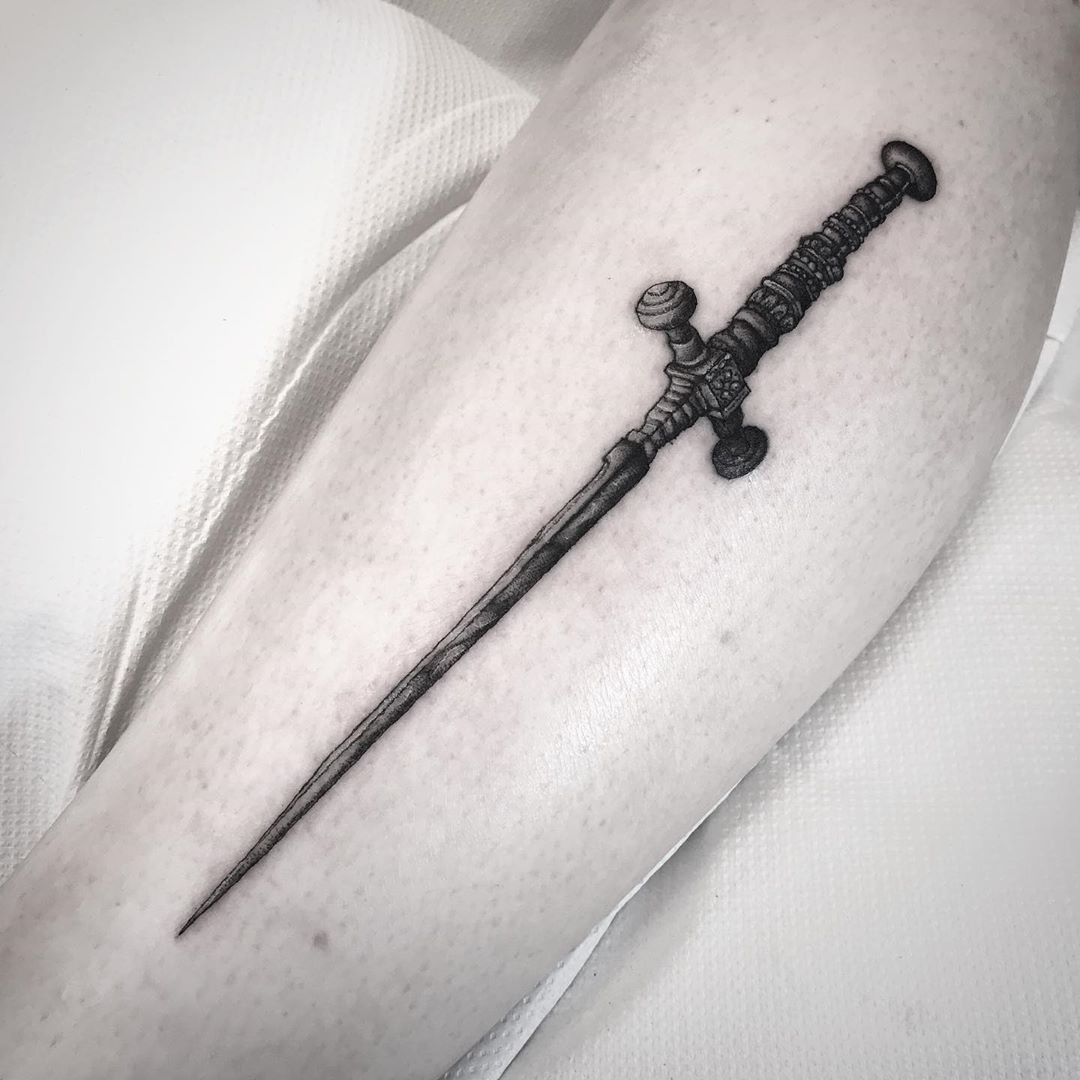 Sword tattoo on the left forearm.