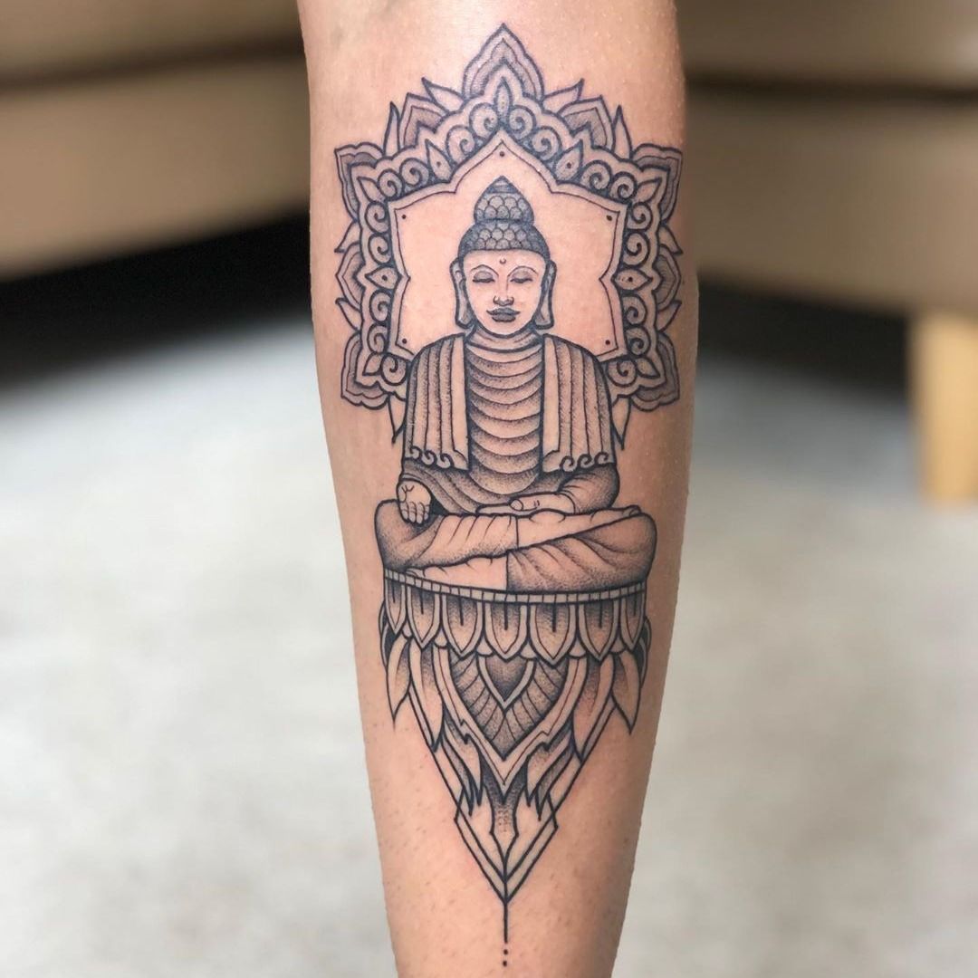 Buddha tattoo behind the right ear.