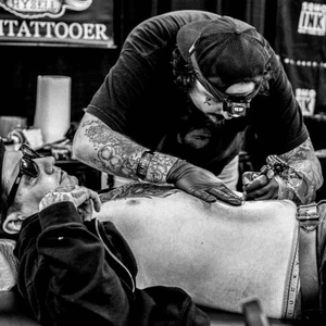 Chazz tattooing at The All American Tattoo Convention - portrait by cmarinophotos