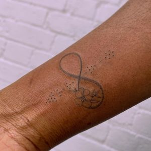 Infinity symbol tattoo by Jade Chanel #JadeChanel #infinity #symbol #dots #flower #smalltattoo #meaingfultattoo #sexualassaultawarenesstattoo #sexualassaultsurvivortattoo #survivortattoo #tattoosforstrength #selflove #empoweringtattoos