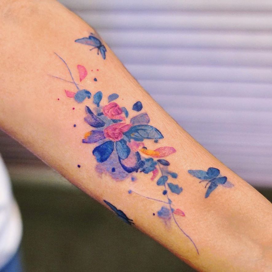 Watercolor flower moon tattoo on the wrist.