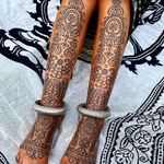 Pattern work tattoo by Swasthik Iyengar aka Gunga Ma #SwasthikIyengar #GungaMa #color #traditional #Hindu #sacredsymbols #sacrediconography #pattern #folkart #linework #dotwork #floral #foot #shin
