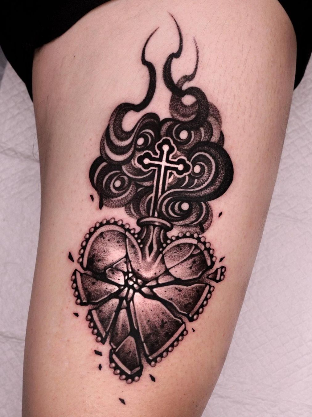 Small cross and heart tattoo on the left wrist