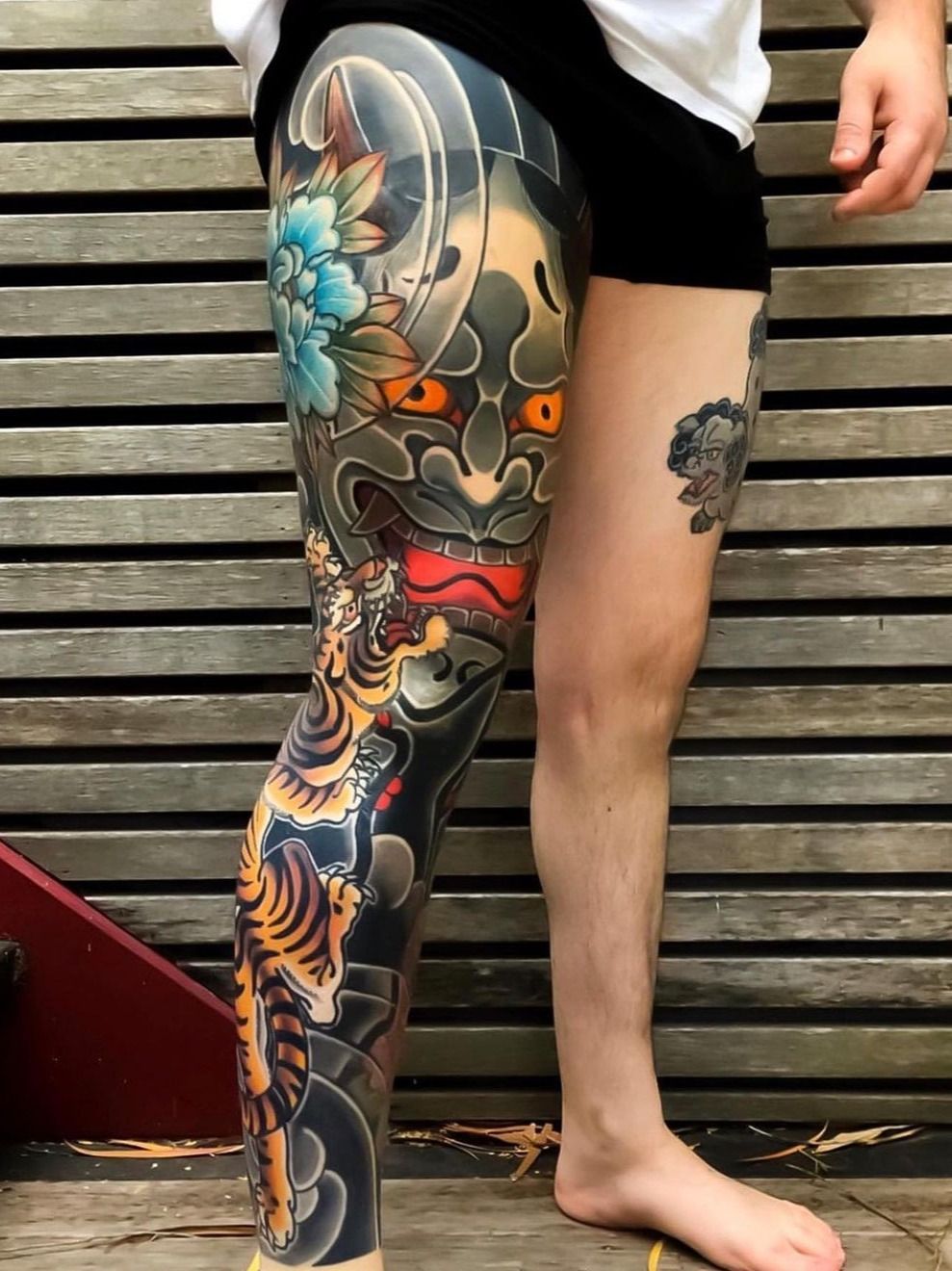 Black and grey tiger tattoo on the right thigh
