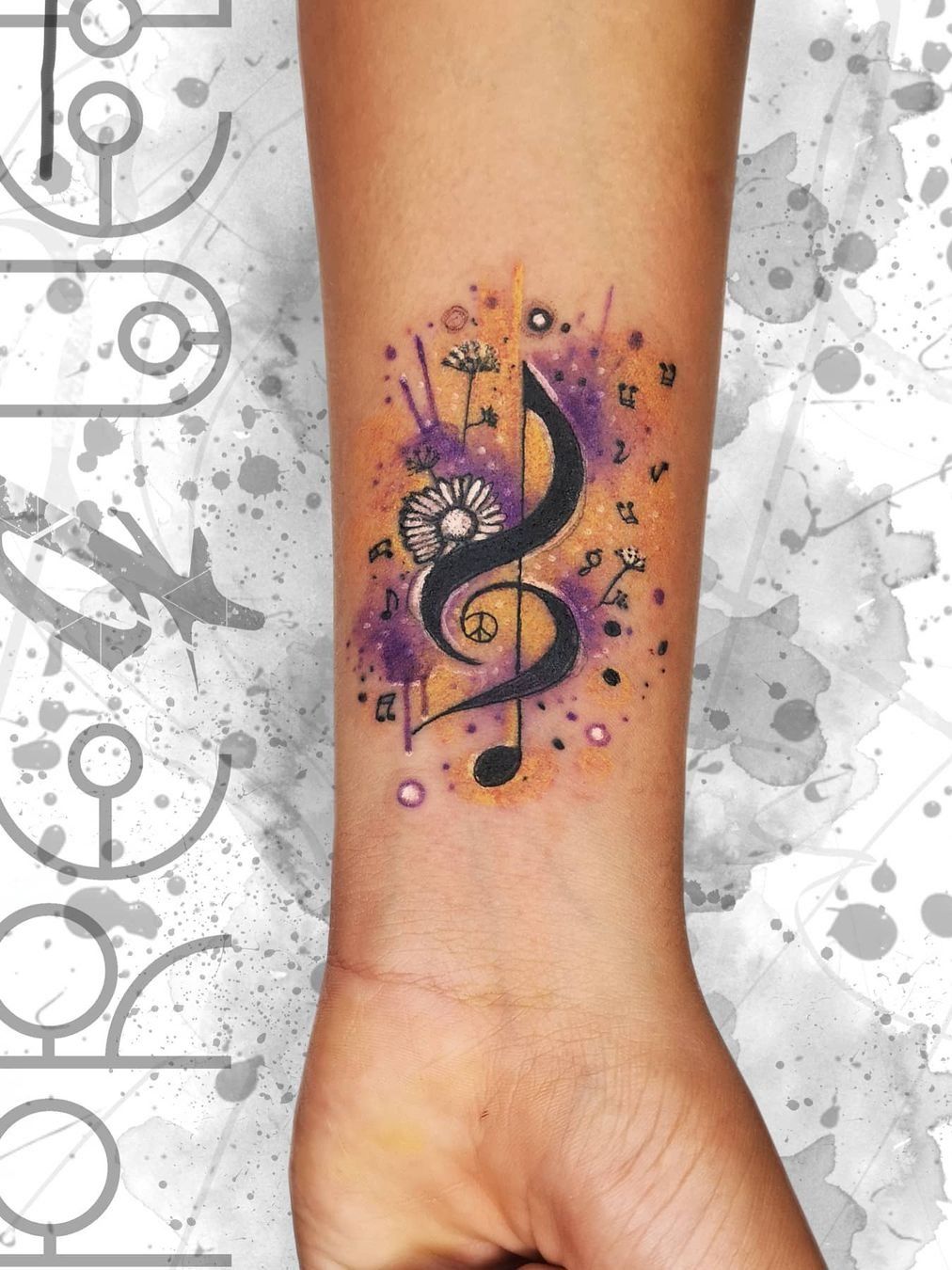 colorful music symbols tattoo