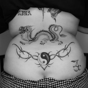 Tattoo by Jordan Baxter #JordanBaxter #illustrative #traditional #oldschool #blackandgrey #yinyang #dragon #barbedwire #trampstamp #lowerback