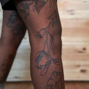 Illustrative tattoo by Nicolas Trotman aka Nick Trotman #NicolasTrotman #NickTrotman #illustrative #blackandgrey #nature #plant #fruit #food #pomegranate #tattoosondarkskin #darkskintattoos #queertattooer #lgbtqia #bipoc #qttr #lgbt #qtbipoc