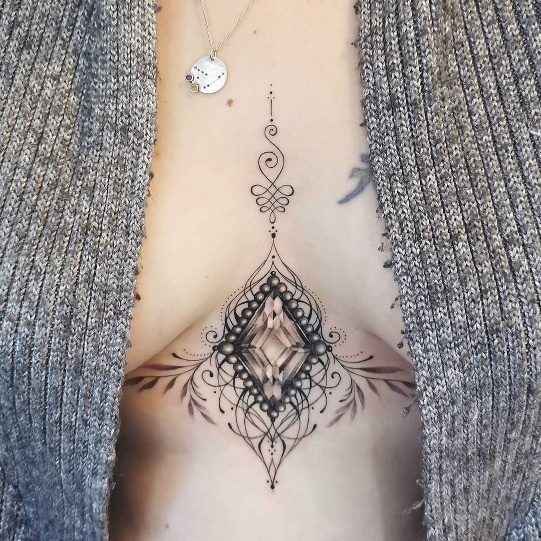 Hand poked white triangle tattoo on the sternum