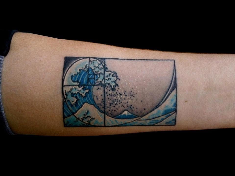 The Fibonacci spiral inside famous painting The Great Wave at Kanagawa by Hokusai, tattooed at Visionary Arts.