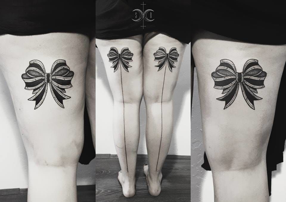 Skull and Red Bow Tattoos On Back Thighs