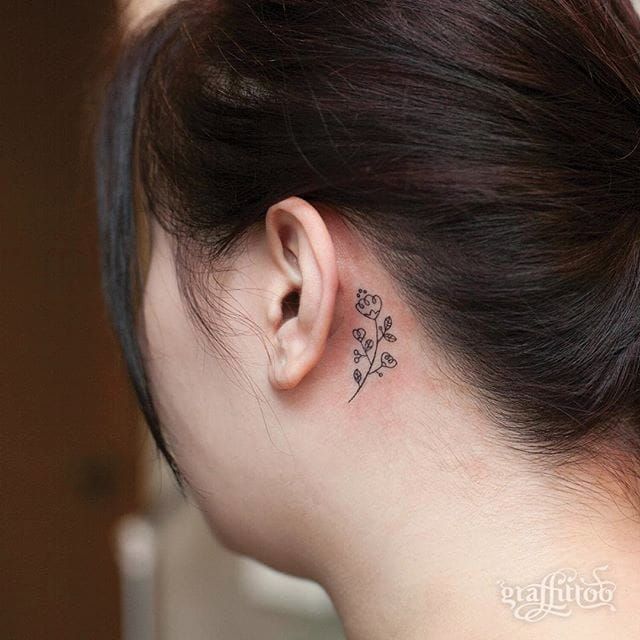 Minimalist flower tattoos on the left ear  Tattoogridnet