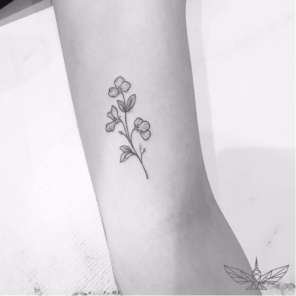 Tiny flower tattoo on left arm - Tattoogrid.net