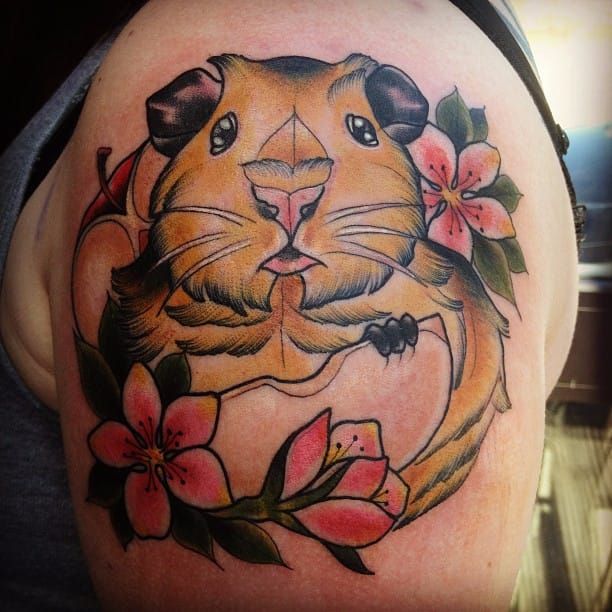Neotraditional guinea pig tattoo on the inner forearm