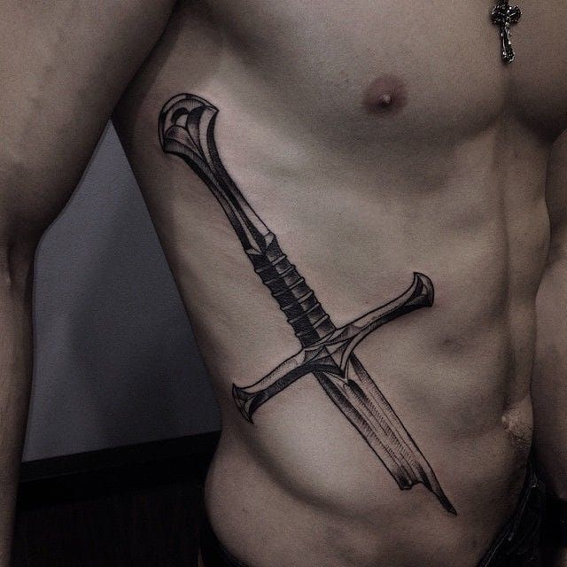Badass rib tattoo of a broken sword by Vildan!