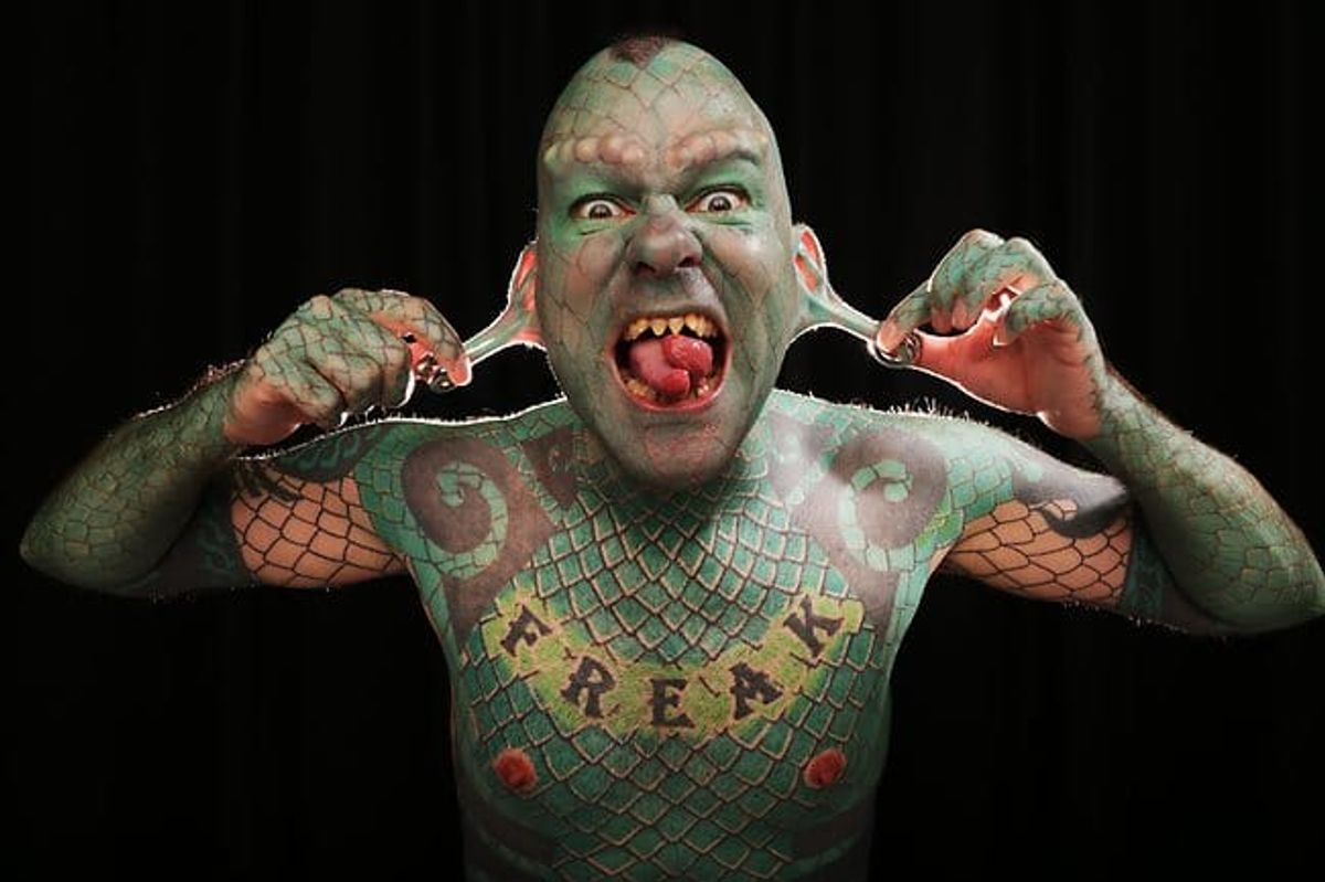 10. Eric Sprague, also known as "The Lizardman", has a full-body tattoo of green scales and has had his teeth filed into sharp points. - wide 4