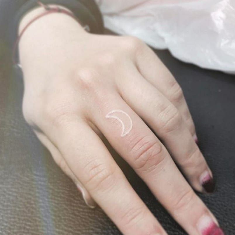 Small moon tattoo on the finger