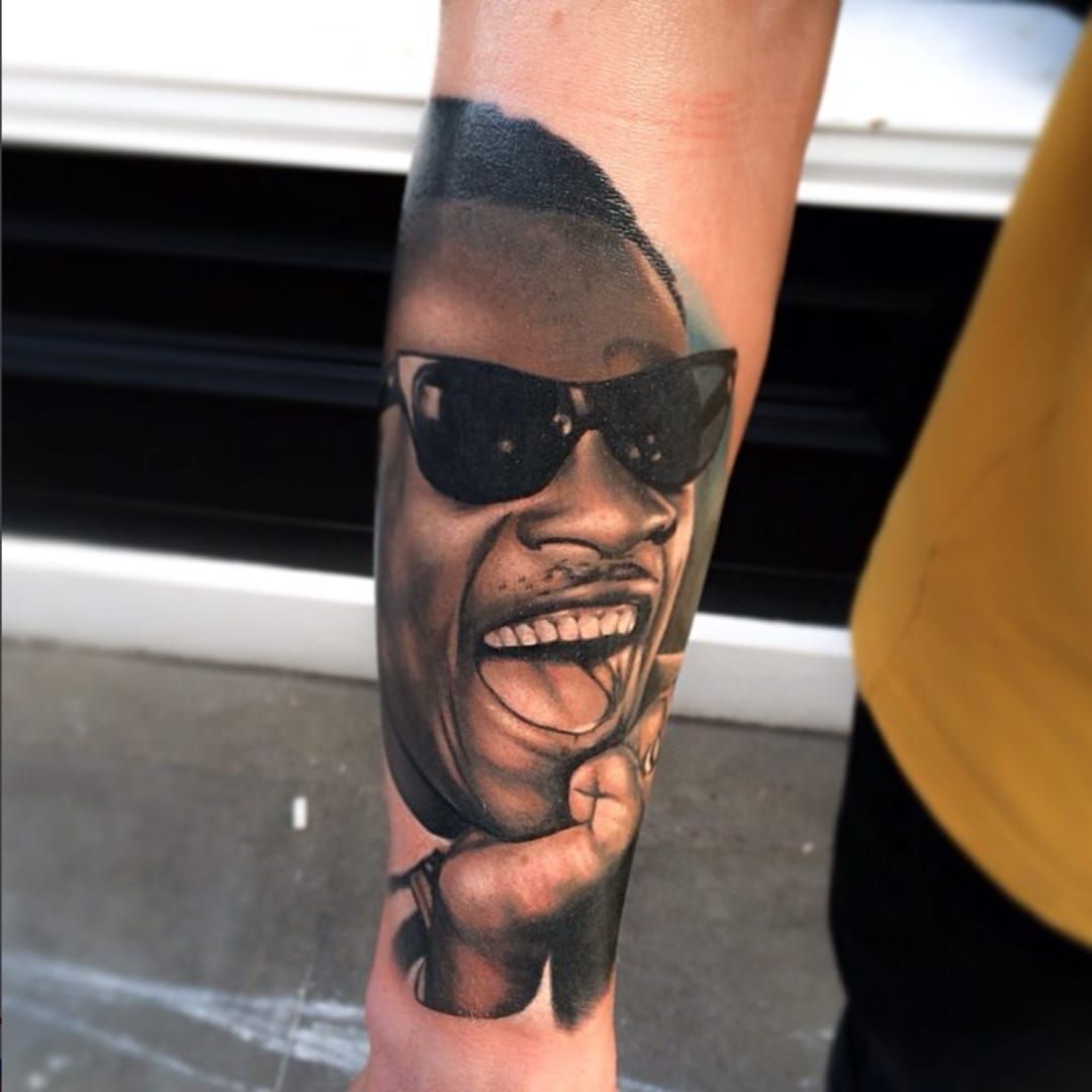 Stevie Wonder portrait tattoo located on the stomach