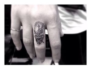 An intricate finger tattoo by Dr Woo...