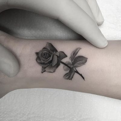 Rose tattoo by Filipe Pacheco #FelipePacheco #flowertattoos #blackandgrey #realism #realistic #small #tiny #flower #floral #leaves #nature #tattoooftheday