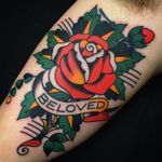 Super clean cover up tattoo by Josh Bovender #JoshBovender #flowertattoos #traditional #color #rose #rosebud #flower #floral #banner #text #quote #beloved #love #leaves #nature