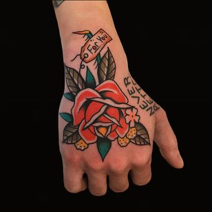 Western traditional tattoo by Alex Zampirri #AlexZampirri #handtattoo #hand #jobstopper #color #traditional #rose #text #tag #leaves #flower #floral