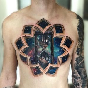 Tattoo by Jesse Rix #JesseRix #chesttattoos #chesttattoo #chest #color #hourglass #opticalillusion #galaxy #stars #stainedglass