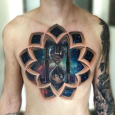 Tattoo by Jesse Rix #JesseRix #chesttattoos #chesttattoo #chest #color #hourglass #opticalillusion #galaxy #stars #stainedglass