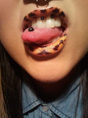 Tattooed lips and lip piercing