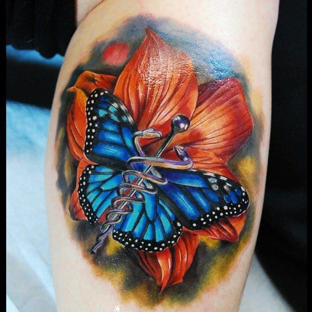 Lovely flower and butterfly as a background for a medical caduceus tattoo by Justin Buduo.