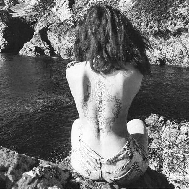 Chakra tattoos are also coveted by followers of the yoga life. Here on the spine by Fliquet Renouf.