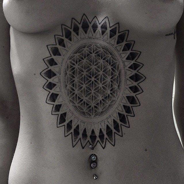 Sacred geometry tattoos also go well with yoga life. By Corey Divine.
