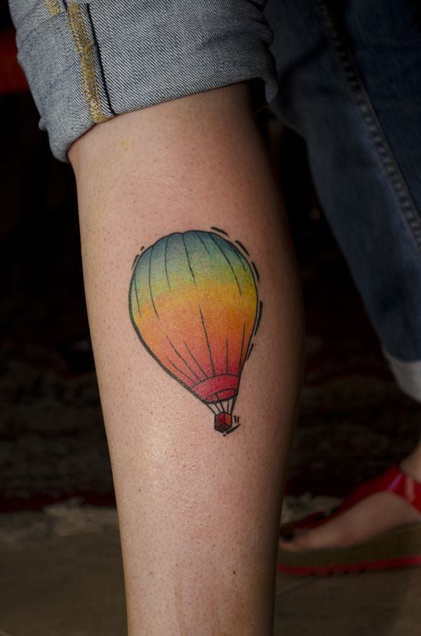 Hot air balloon tattoo located on the tricep