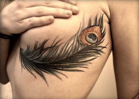 Feather sideboob tattoo, artist unknown.